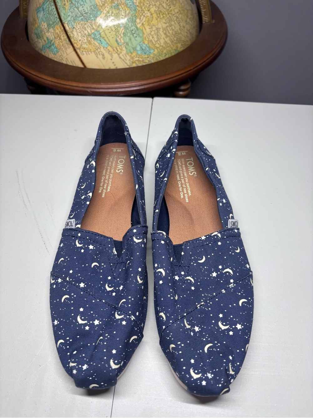 Toms women’s Navy Moon & Star Canvas Slip-Ons